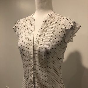 White blouse with black polka dots buttoned